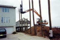 Pile driving a New Jersey shore dwelling utilizing a diesel hammer. This method allows us to get piles driven in tight work spaces.